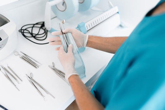doctor is standing with different dental instruments